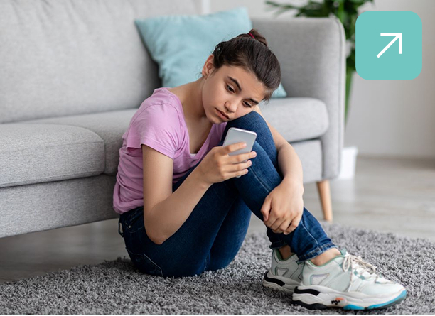 Child-on-phone Child sat on floor on her phone